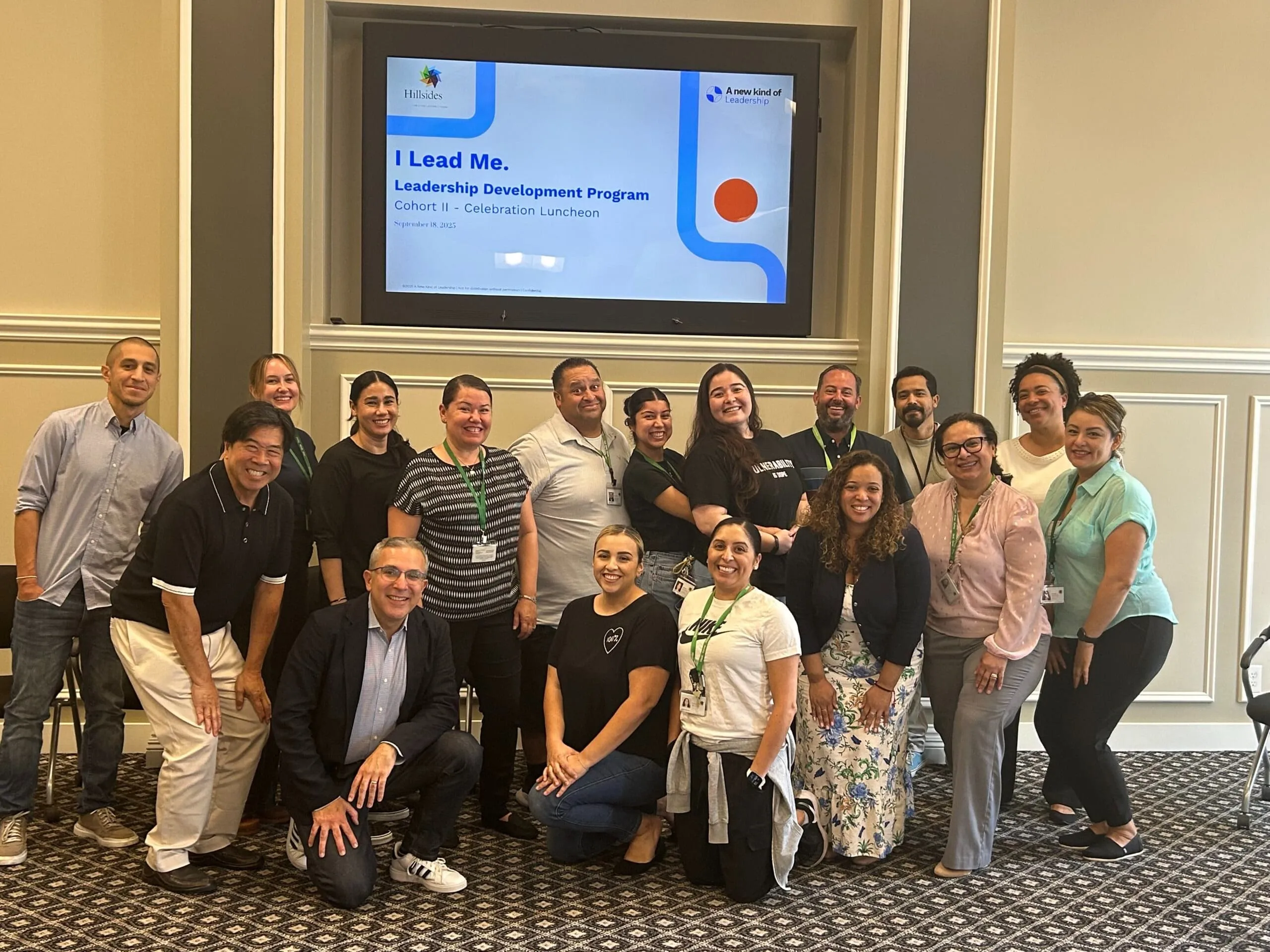 Group of professionals celebrating the completion of a leadership development program focused on self-leadership and team growth